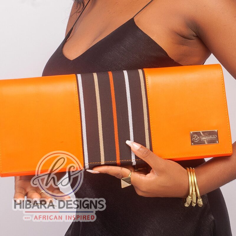 Our shangani bag is a leather clutch Bag Accented with Asooke