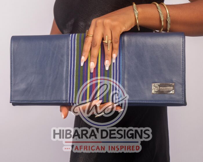 Our shangani bag is a leather clutch Bag Accented with Asooke