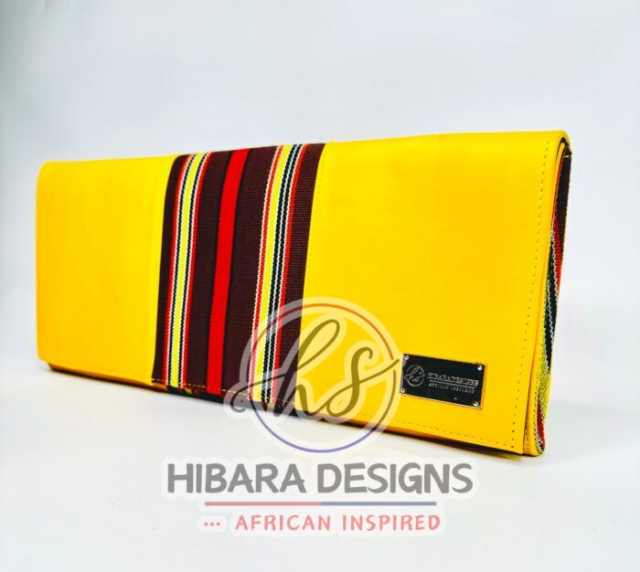 Our shangani bag is a leather clutch Bag Accented with Asooke