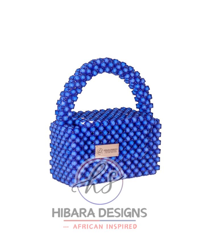 Introducing the Efik Collection, your new favorite IT bag She's bold, she's beautiful, she's BEADED, and most importantly, she sparkles when she enters the room, just like YOU! Handcrafted with love by female artisans from Lagos, Nigeria. Dimension: 7x10 inches Material: Blue Crystal Beads Interior: Satin-lined Your Efik bag is handcrafted specially, just for you! Due to the craftsmanship and time it takes to make each bag, please allow up to 2 to 4 weeks for your order to be shipped.