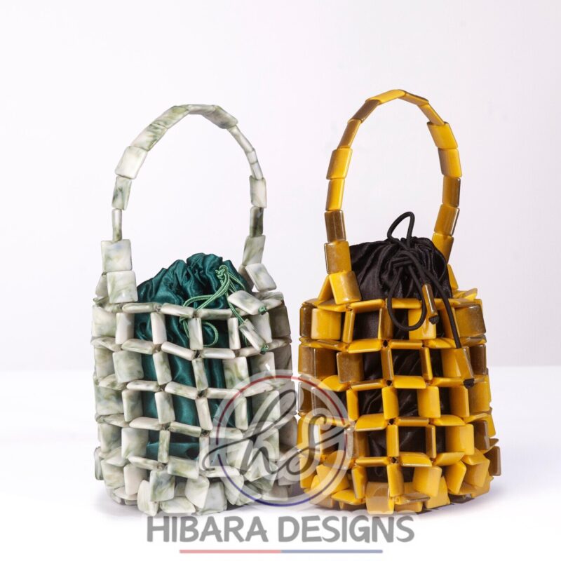 Introducing the Noemi bucket bag Collection, one of our exciting, piece. This bag can be Dress up,brunch with the girls or weekend getaway with the man. She absolutely that IT bag needed to spice any outfit! Handcrafted with love by our young artisans of Lagos, Nigeria Interior: removal Satin pouch Material: Beads Measurement: length-5 inches width - 5 inches