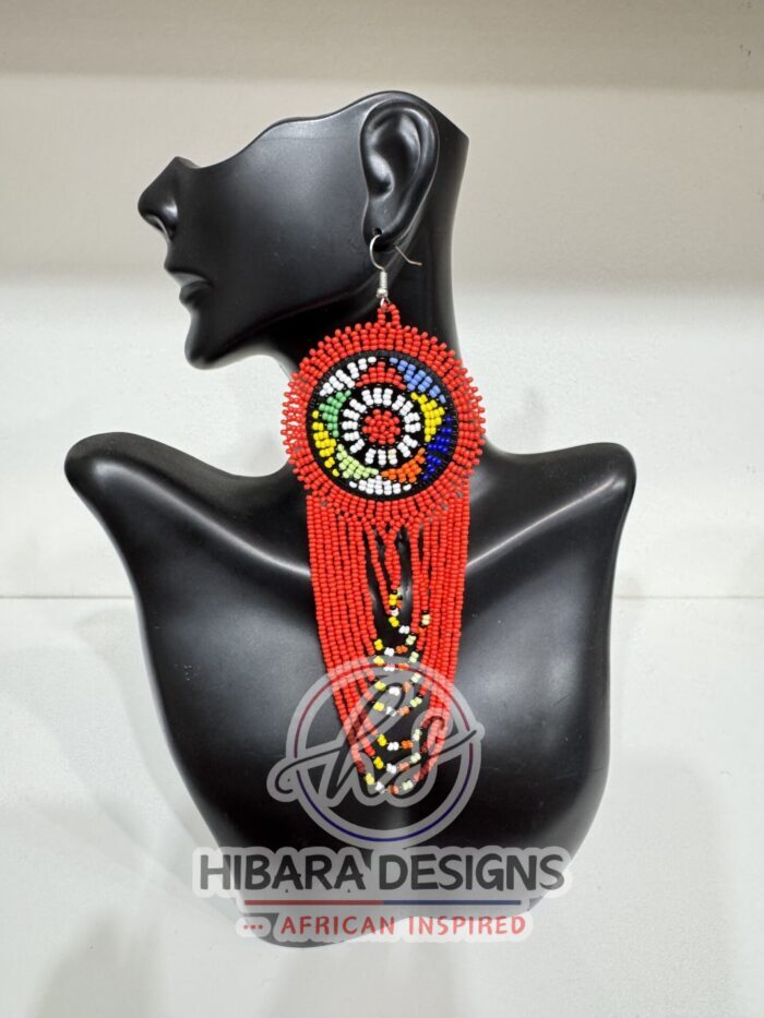 These earrings are traditionally handmade beaded by the Zulu women in South Africa. Nandi Beaded Earrings with Large Circle and beaded drop African Beaded Earrings with multiple colors Large Circle beads cascading down. Nandi Beaded earrings is very lightweight earrings that worn for any occasions. We believe that this piece of earrings is a must in every female jewelries collection. Zulu Beaded Earrings Made from colorful seed beads Earrings are very lightweight Size: 3.5in width earring hook post with rubber earring backs provided