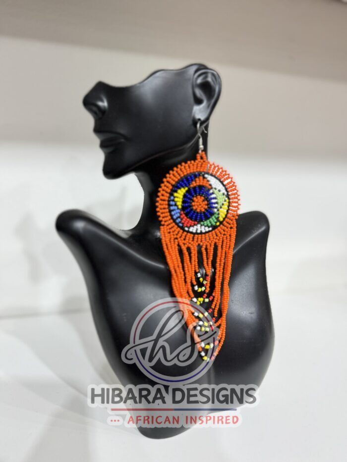 These earrings are traditionally handmade beaded by the Zulu women in South Africa. Nandi Beaded Earrings with Large Circle and beaded drop African Beaded Earrings with multiple colors Large Circle beads cascading down. Nandi Beaded earrings is very lightweight earrings that worn for any occasions. We believe that this piece of earrings is a must in every female jewelries collection. Zulu Beaded Earrings Made from colorful seed beads Earrings are very lightweight Size: 3.5in width earring hook post with rubber earring backs provided