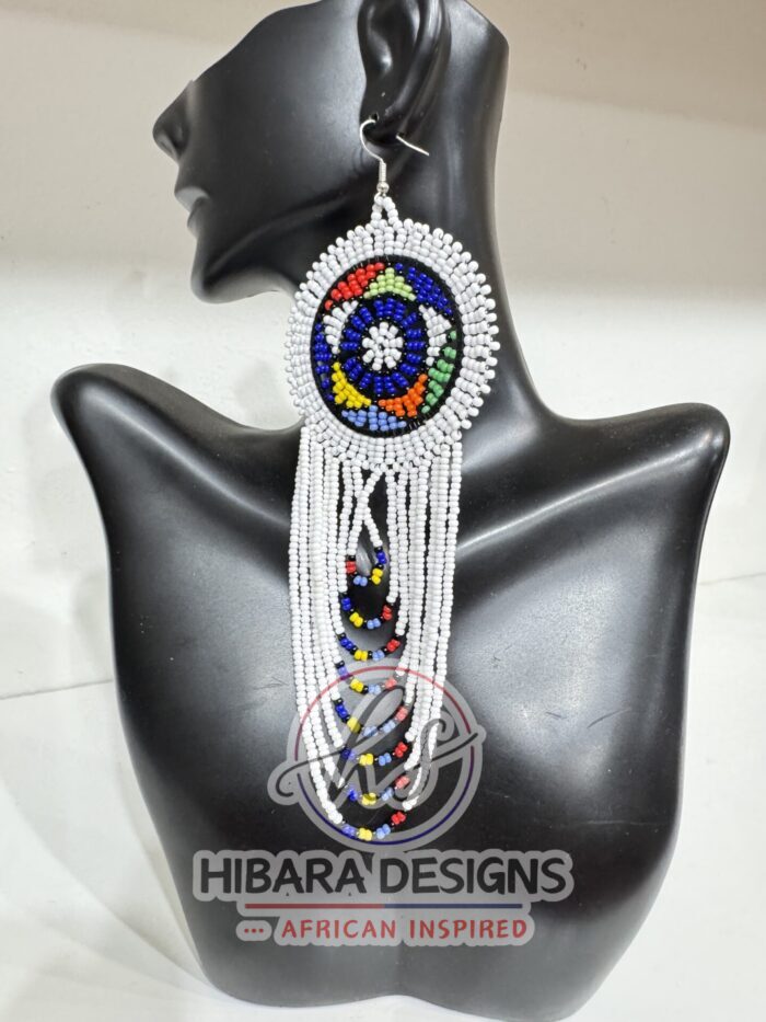 These earrings are traditionally handmade beaded by the Zulu women in South Africa. Nandi Beaded Earrings with Large Circle and beaded drop African Beaded Earrings with multiple colors Large Circle beads cascading down. Nandi Beaded earrings is very lightweight earrings that worn for any occasions. We believe that this piece of earrings is a must in every female jewelries collection. Zulu Beaded Earrings Made from colorful seed beads Earrings are very lightweight Size: 3.5in width earring hook post with rubber earring backs provided